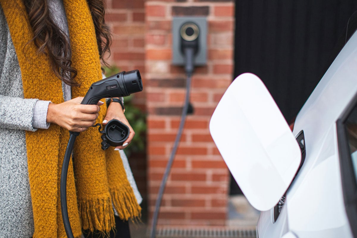 woman with EV charger